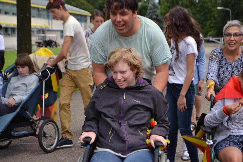 Wandeling met ouders en kinderen, sommigen in een rolstoel.