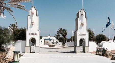 Twee witte torentjes met Griekse vlaggen markeren de ingang van het kuuroord.